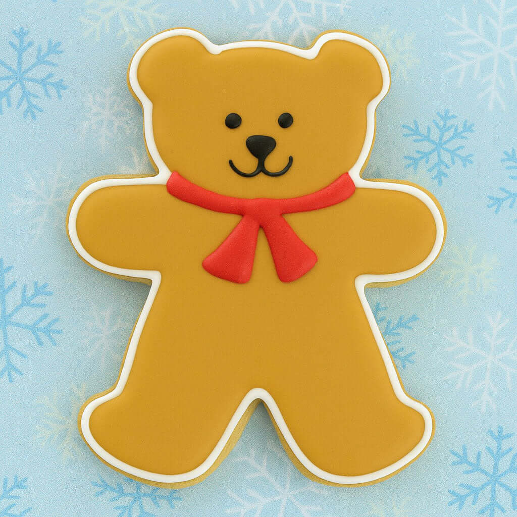 Decorative bear cookie with a red bow on a blue background with snowflakes from a 4 inch Teddy Bear Metal Cookie Cutter