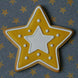 Star-shaped cookie with yellow exterior and white center on a star-patterned background from a 2.5 inch Star Metal Cookie Cutter