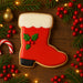 4 inch Santa Boot Metal Cookie Cutter displayed with festive decorations and holiday treats.