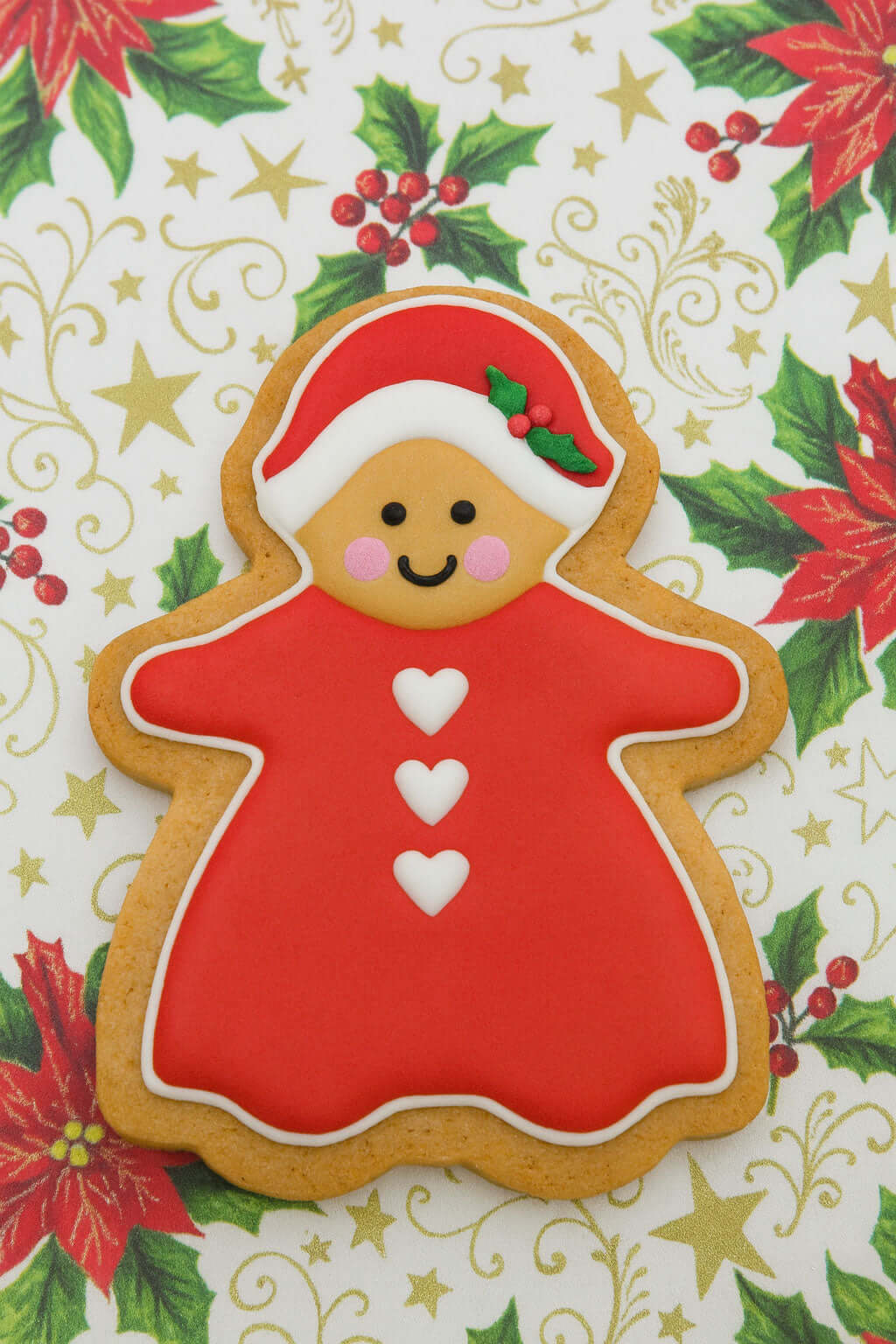 5 inch Gingerbread Girl Metal Cookie Cutter with red dress and festive decorations on a holiday background.