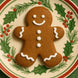 2.25 inch Mini Gingerbread Boy Metal Cookie Cutter with decorated gingerbread boy cookie on holly plate.