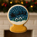 3.5 inch Snow Globe Metal Cookie Cutter shaped cookie with a holiday design featuring Santa and reindeer.