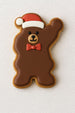 Brown bear-shaped cookie with a red bow tie and Santa hat on a white textured background from a 3.75 inch Waving Santa Metal Cookie Cutter