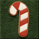 Candy cane-shaped cookie on a green textured background from a 5 inch Candy Cane Metal Cookie Cutter