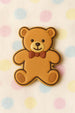 Teddy bear-shaped cookie with a bow tie on a polka dot background from a 3 inch Teddy Bear Metal Cookie Cutter