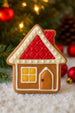 3.5 inch Gingerbread House Metal Cookie Cutter shaped gingerbread cookie decorated with icing.