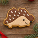 3.75 inch Double Bells Metal Cookie Cutter shaped hedgehog cookie decorated with white icing on wooden background.