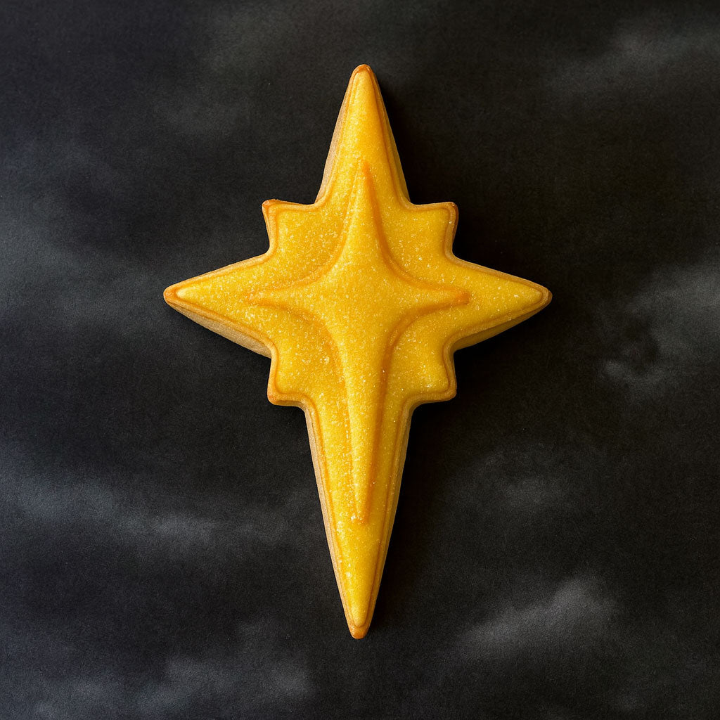 Yellow star-shaped object on a black background from a 3.5 inch Star of Bethlehem Moravian Star Metal Cookie Cutter