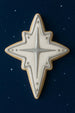 3.5 inch Star of Bethlehem Moravian Star Metal Cookie Cutter decorated cookie with white icing and silver details.