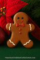 3 inch Gingerbread Boy Metal Cookie Cutter displayed with decorated gingerbread cookie and festive decorations.