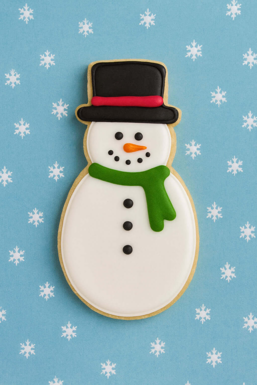 5 inch Snowman Metal Cookie Cutter shaped cookie decorated with a black hat, green scarf, and festive icing.