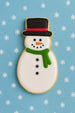 5 inch Snowman Metal Cookie Cutter shaped cookie decorated with a black hat, green scarf, and festive icing.