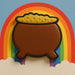 Cookie shaped like a pot of gold with a rainbow in the background from a 3.5 inch Pot O Gold or Witch's Cauldron Metal Cookie Cutter