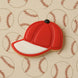 Red baseball cap cookie on a background with baseball patterns from a 3 inch Baseball Cap Metal Cookie Cutter