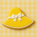 Yellow hat cookie with a white bow on a yellow checkered background from a 4.5 inch Easter Bonnet or Beach Hat Metal Cookie Cutter