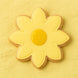 flower-shaped cookie with yellow icing on a yellow background from a 3.5 inch Daisy Flower Metal Cookie Cutter