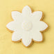 Decorative cookie shaped like a flower with white icing on a yellow background from a 2.25 inch Mini Daisy Flower Metal Cookie Cutter