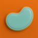 Teal bean-shaped object on an orange background from a 3.5 inch Jellybean Metal Cookie Cutter