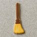 Cookie shaped like a broom with a brown handle on a gray surface from a 5 inch Witch's Broom Metal Cookie Cutter