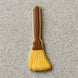 Cookie shaped like a broom with a brown handle on a gray surface from a 5 inch Witch's Broom Metal Cookie Cutter