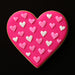 Heart-shaped cookie with pink and white heart decorations on a black background from a 2.25 inch Heart Metal Cookie Cutter