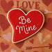 Heart-shaped cookie with 'Be Mine' text on a Valentine's Day-themed background from a 3.5 inch Heart Metal Cookie Cutter