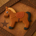4 inch Horse Metal Cookie Cutter shaped like a brown horse on a rustic background.