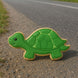 Green turtle-shaped cookie on a road from a 4.75 inch Turtle Metal Cookie Cutter