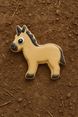 Cookie-shaped donkey on a brown textured surface from a 3.75 inch Donkey Metal Cookie Cutter