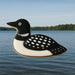 Loon-shaped cookie on a body of water with trees in the background from a 4.75 inch Loon Metal Cookie Cutter