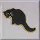 Black cat-shaped cookie on a silver background from a 5.5 inch Cat Metal Cookie Cutter