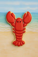 4 inch Lobster or Crawfish Metal Cookie Cutter shaped cookie on a beach background.