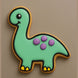 Brontosaurus-shaped cookie with green body, purple spots, and yellow feet on a beige background from a 4 inch Brontosaurus Metal Cookie Cutter