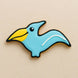 Cookie shaped like a blue pterodactyl  with a yellow beak on a beige background from a 4.75 inch Pterodactyl Metal Cookie Cutter