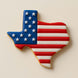 Cookie shaped like Texas with American flag design on a beige background from a 3.5 inch Texas Metal Cookie Cutter