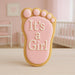Cookie shaped like a foot with 'It's a Girl' text on a pink background from a 3.5 inch Right Foot Metal Cookie Cutter