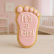 Cookie shaped like a foot with 'It's a Girl' text on a pink background from a 3.5 inch Right Foot Metal Cookie Cutter