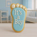 Cookie shaped like a baby footprint with 'It's a Boy' text in a nursery setting from a 3.5 inch Right Foot Metal Cookie Cutter