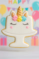 Unicorn-shaped cookie with colorful decorations on a stand against a festive background with balloons and streamers from a 4 inch Unicorn Cake Stand Metal Cookie Cutter