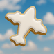 Cookie shaped like an airplane against a blue sky background from a 3.75 inch Airplane Metal Cookie Cutter