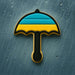 Cookie-shaped umbrella with blue and yellow stripes on a textured gray background from a 3 inch Umbrella Metal Cookie Cutter