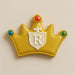Decorative cookie shaped like a crown with a letter 'R' on a beige background from a5 inch Crown Metal Cookie Cutter