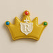 Decorative cookie shaped like a crown with a letter 'R' on a beige background from a5 inch Crown Metal Cookie Cutter