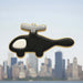 Black and silver cookie shaped like a helicopter with a city skyline in the background from a 5 inch Helicopter Metal Cookie Cutter
