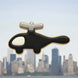Black and silver cookie shaped like a helicopter with a city skyline in the background from a 5 inch Helicopter Metal Cookie Cutter
