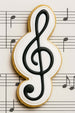 Cookie shaped like a g clef on sheet music from a 4 inch G Clef Metal Cookie Cutter