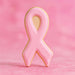 3.75 inch Awareness Ribbon Metal Cookie Cutter shaped pink cookie on a pastel pink background.