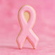 3.75 inch Awareness Ribbon Metal Cookie Cutter shaped pink cookie on a pastel pink background.