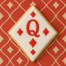 Cookie shaped like a playing card with a red 'Q' on a red patterned background from a 3.5 inch Diamond Metal Cookie Cutter