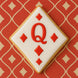 Cookie shaped like a playing card with a red 'Q' on a red patterned background from a 3.5 inch Diamond Metal Cookie Cutter